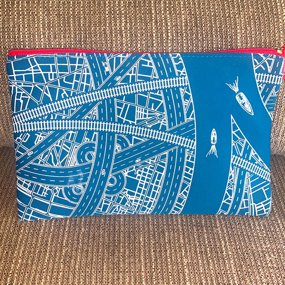 Blue and White Emirates Toiletry Bag with travel necessities and a Dubai flyer